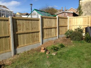 Smooth white concrete slotted posts with close board fence panel